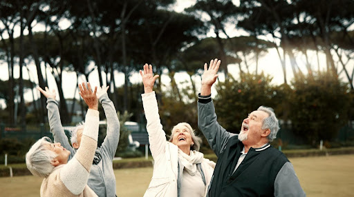 Seniors celebrating outdoors.