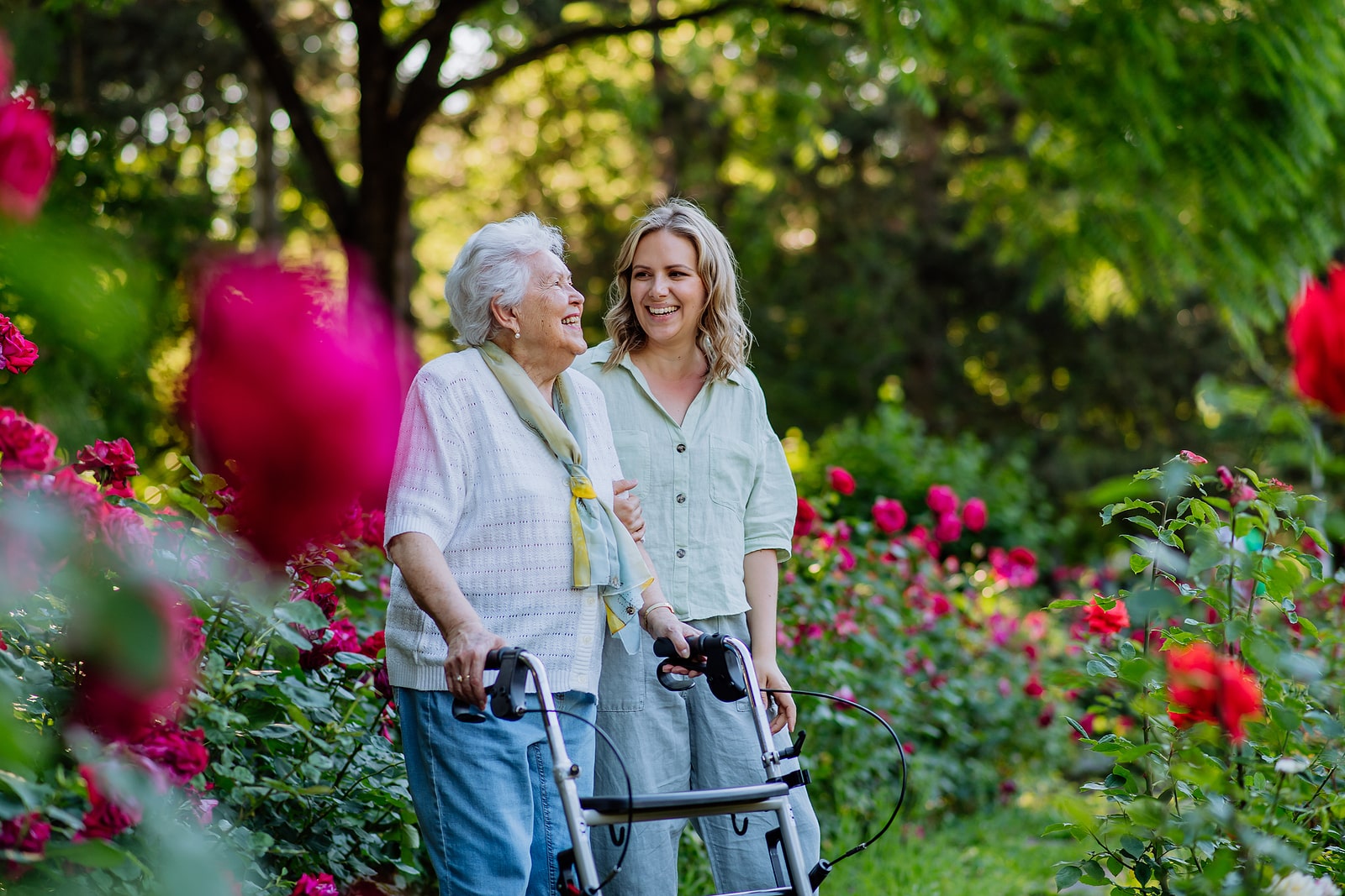 woman walking with senior woman outside