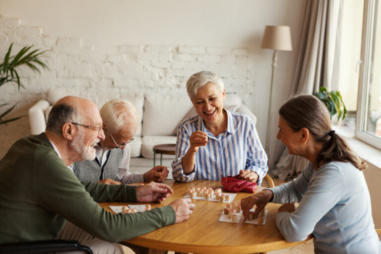 Group of seniors men and women, playing board games