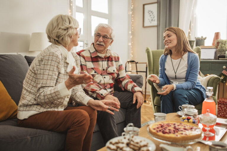 Senior couple discussing the weekend with caregiver